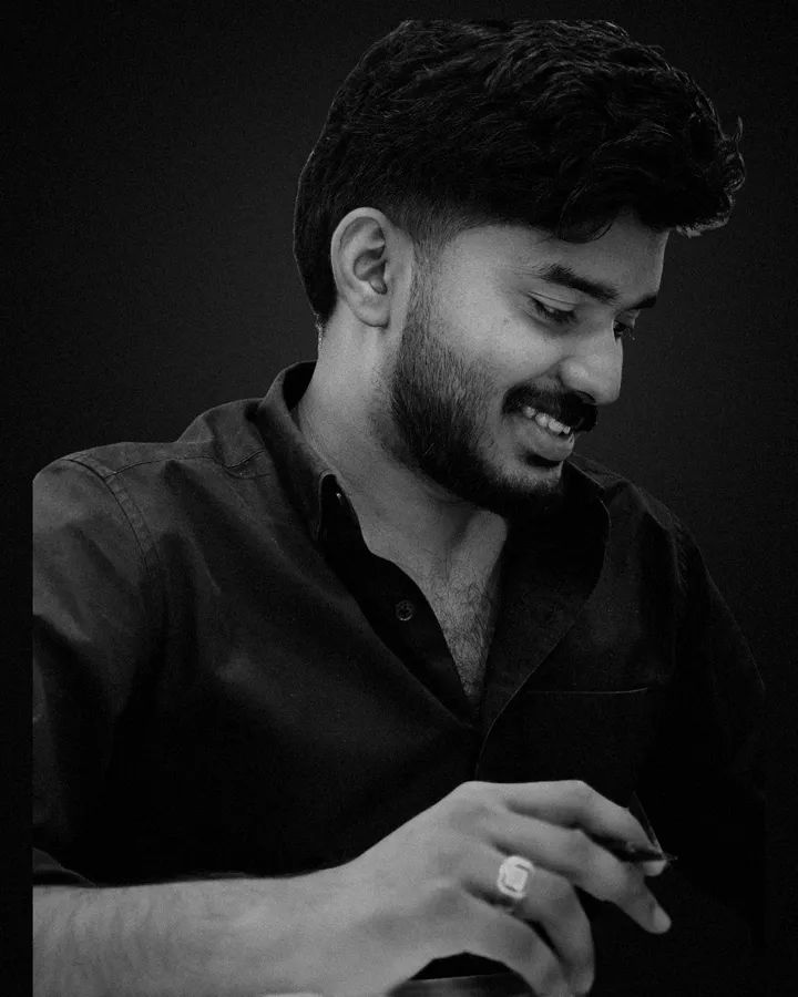 Shadi smiling, writing at his desk