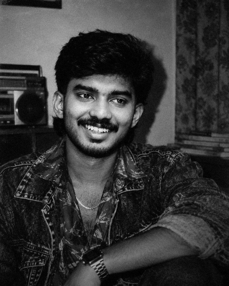 Shadi smiling in a denim jacket, black and white